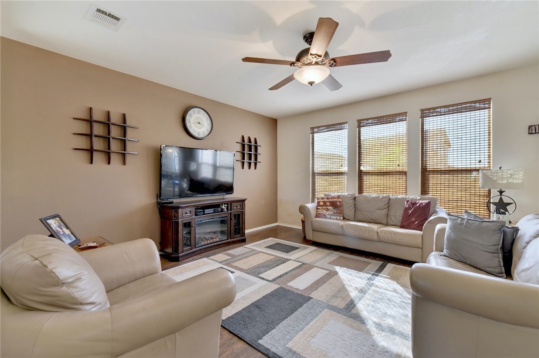 145 Rudy Lane Kyle, TX 78640 - Photo 8 of 29 a living room with furniture and a flat screen tv