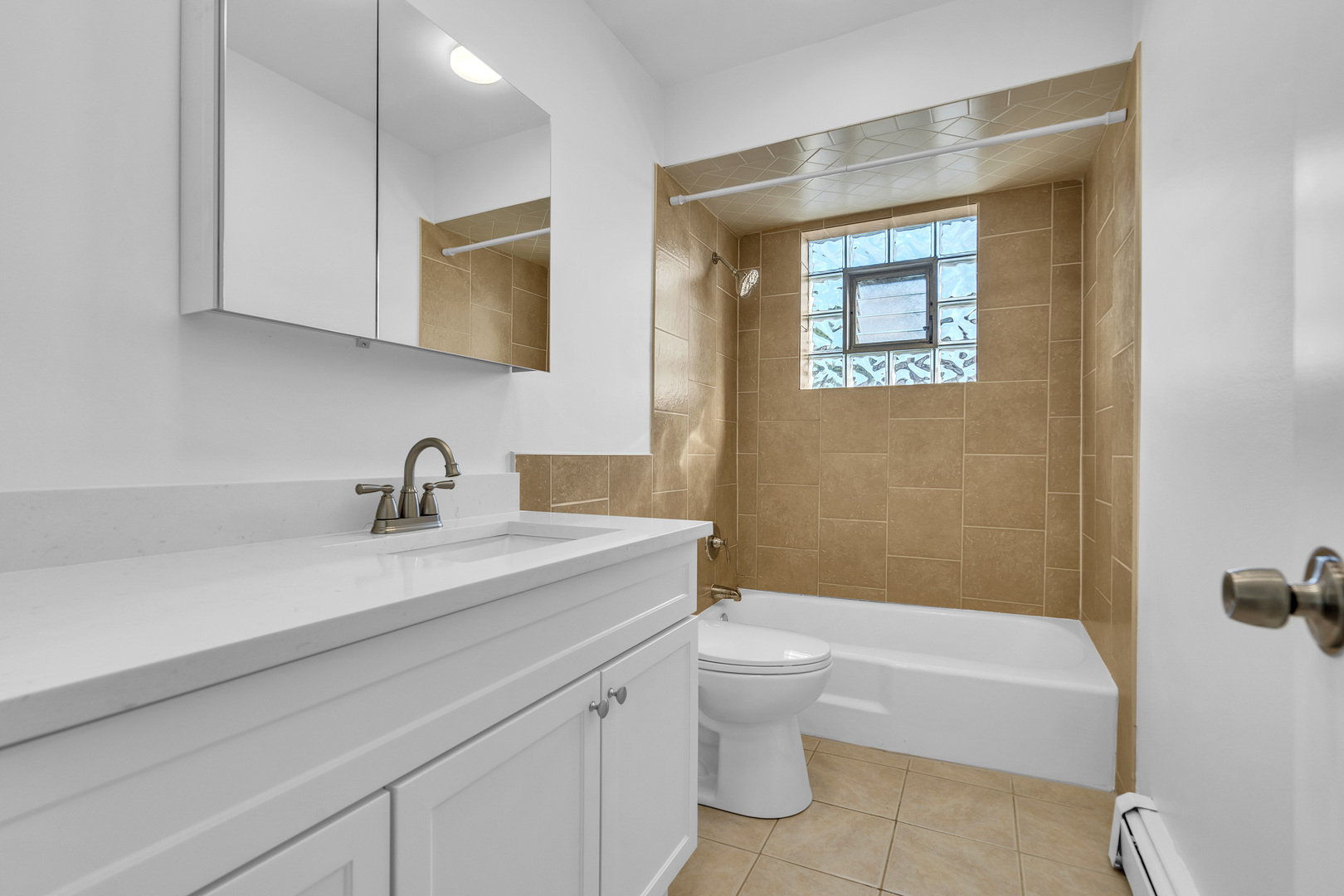 512 Ida Court, Unit 2 Mount Prospect, IL 60056 - Photo 6 of 16 a bathroom with a granite countertop sink a toilet and bathtub
