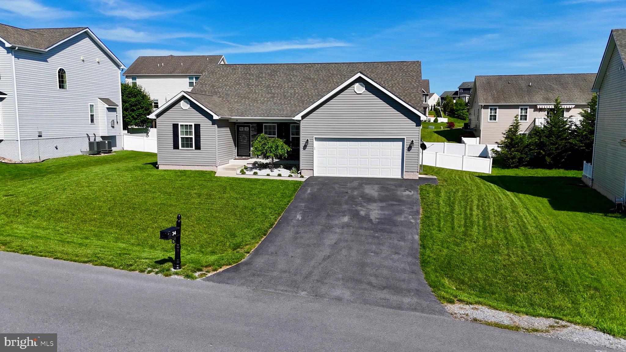 34 Constellation Road Inwood, WV 25428 - Photo 6 of 64 a front view of a house with a yard and garage