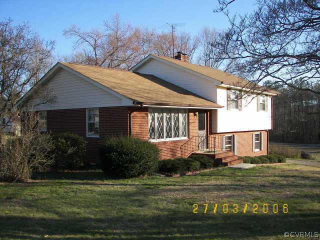11543 Doswell Road Doswell, VA 23047 - Photo 7 of 8 a front view of a house with a garden and tree