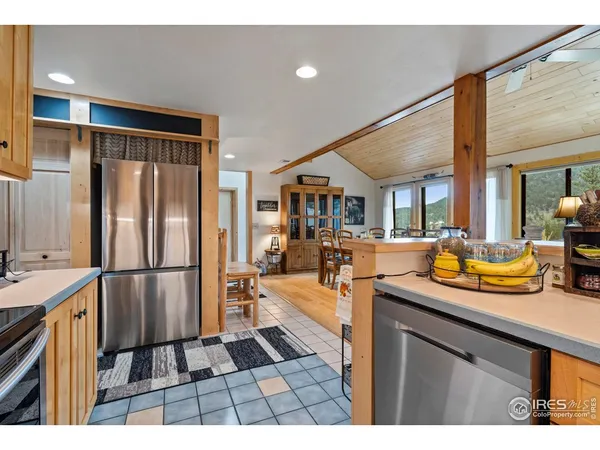 a kitchen with sink refrigerator and cabinets