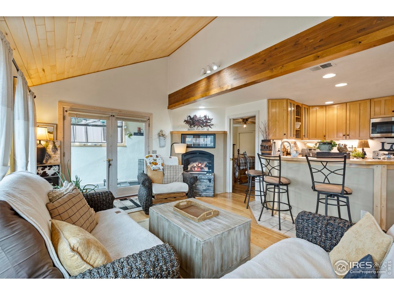 123 Mohawk Road Lyons, CO 80540 - Photo 9 of 38 a living room with fireplace furniture and a view of kitchen