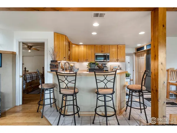 a kitchen view with a refrigerator a stove and a sink