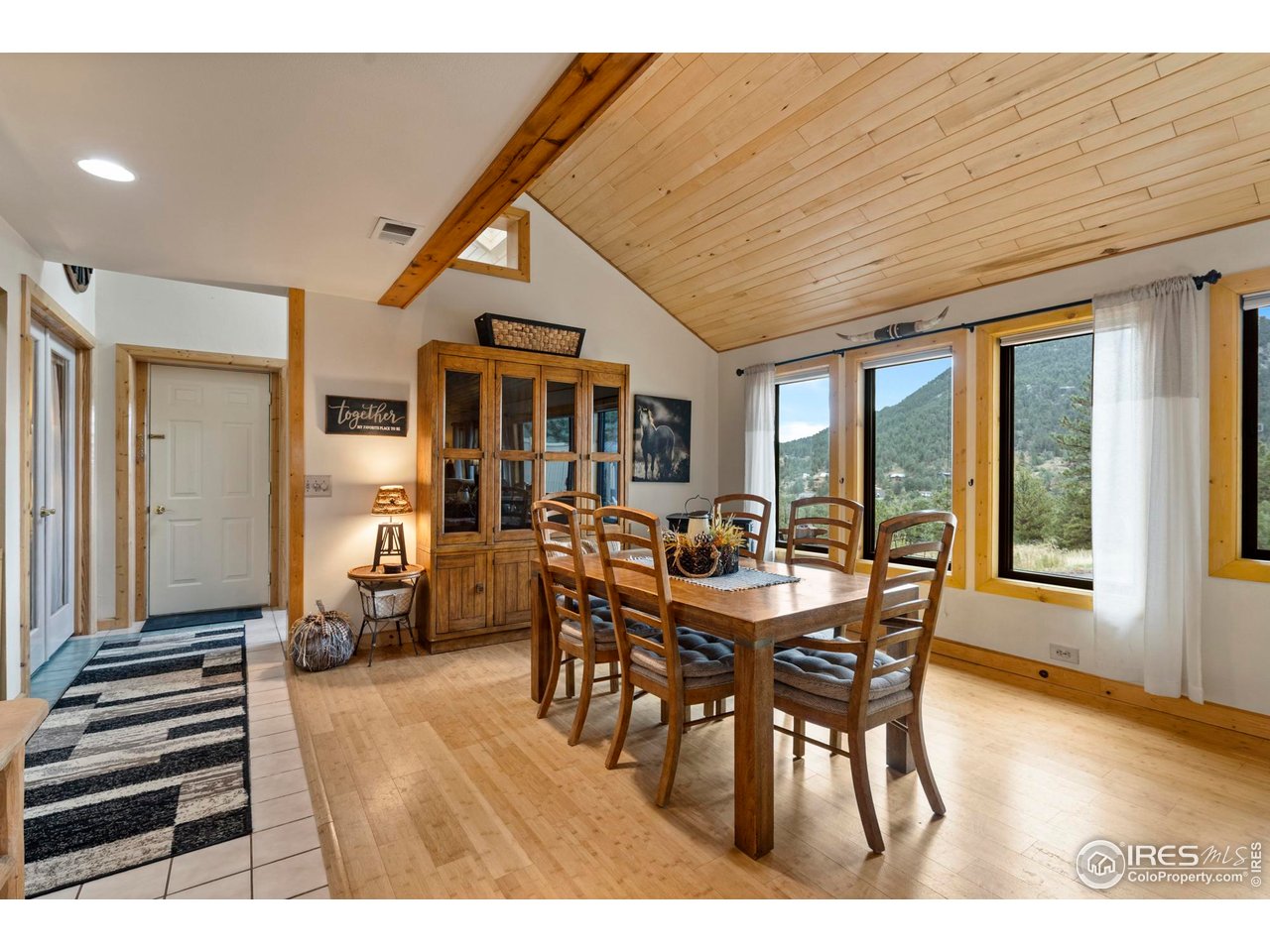 123 Mohawk Road Lyons, CO 80540 - Photo 13 of 38 a dining room with furniture window and wooden floor