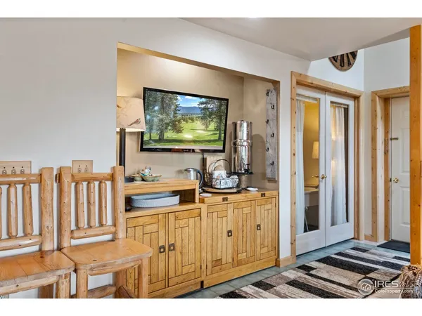 a dining room with furniture window and wooden floor