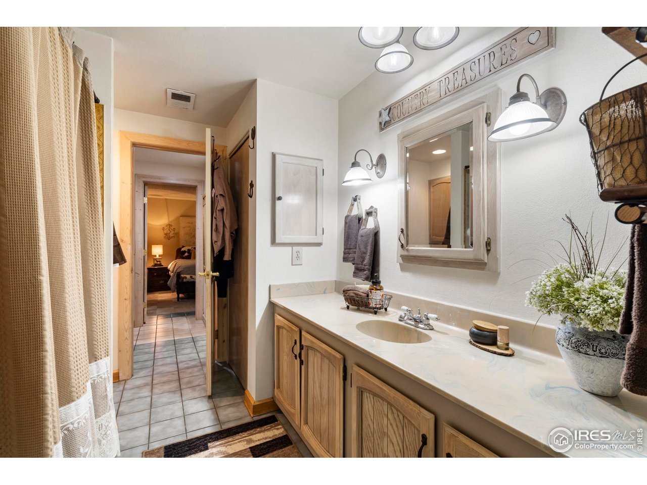 123 Mohawk Road Lyons, CO 80540 - Photo 19 of 38 a bathroom with a sink a mirror and shower