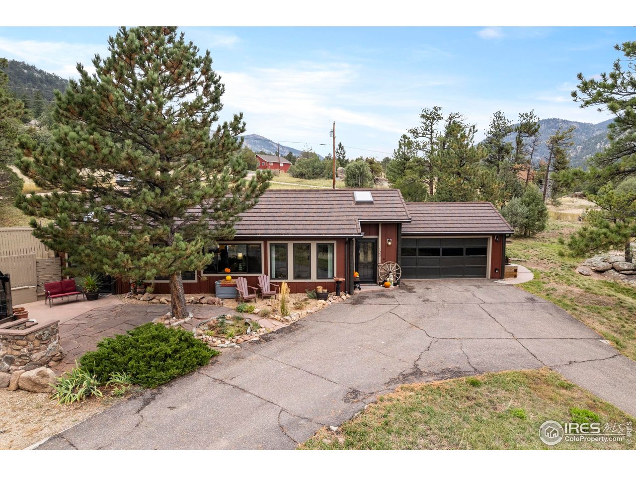 123 Mohawk Road Lyons, CO 80540 - Photo 23 of 38 a view of a patio with table and chairs under an umbrella
