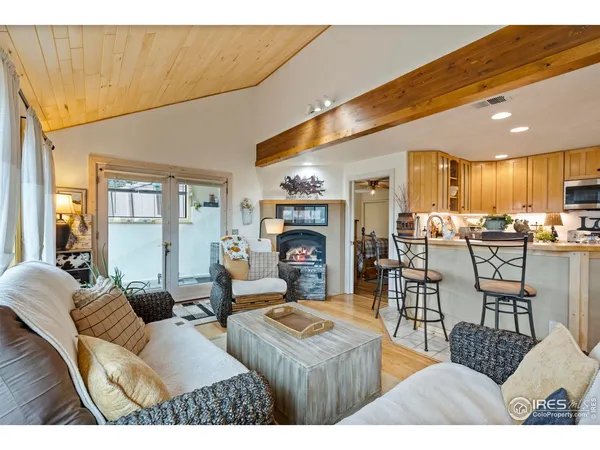 a living room with furniture and a view of kitchen