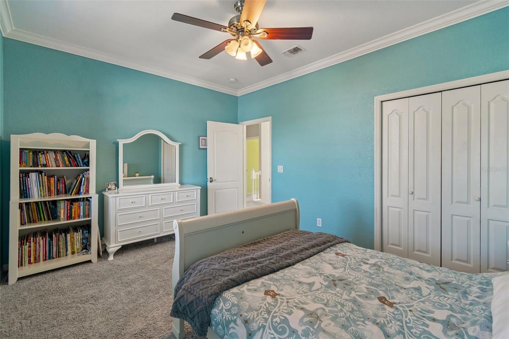 703 Bunker View Drive Apollo Beach, FL 33572 - Photo 28 of 49 a bedroom with a bed and a book shelf