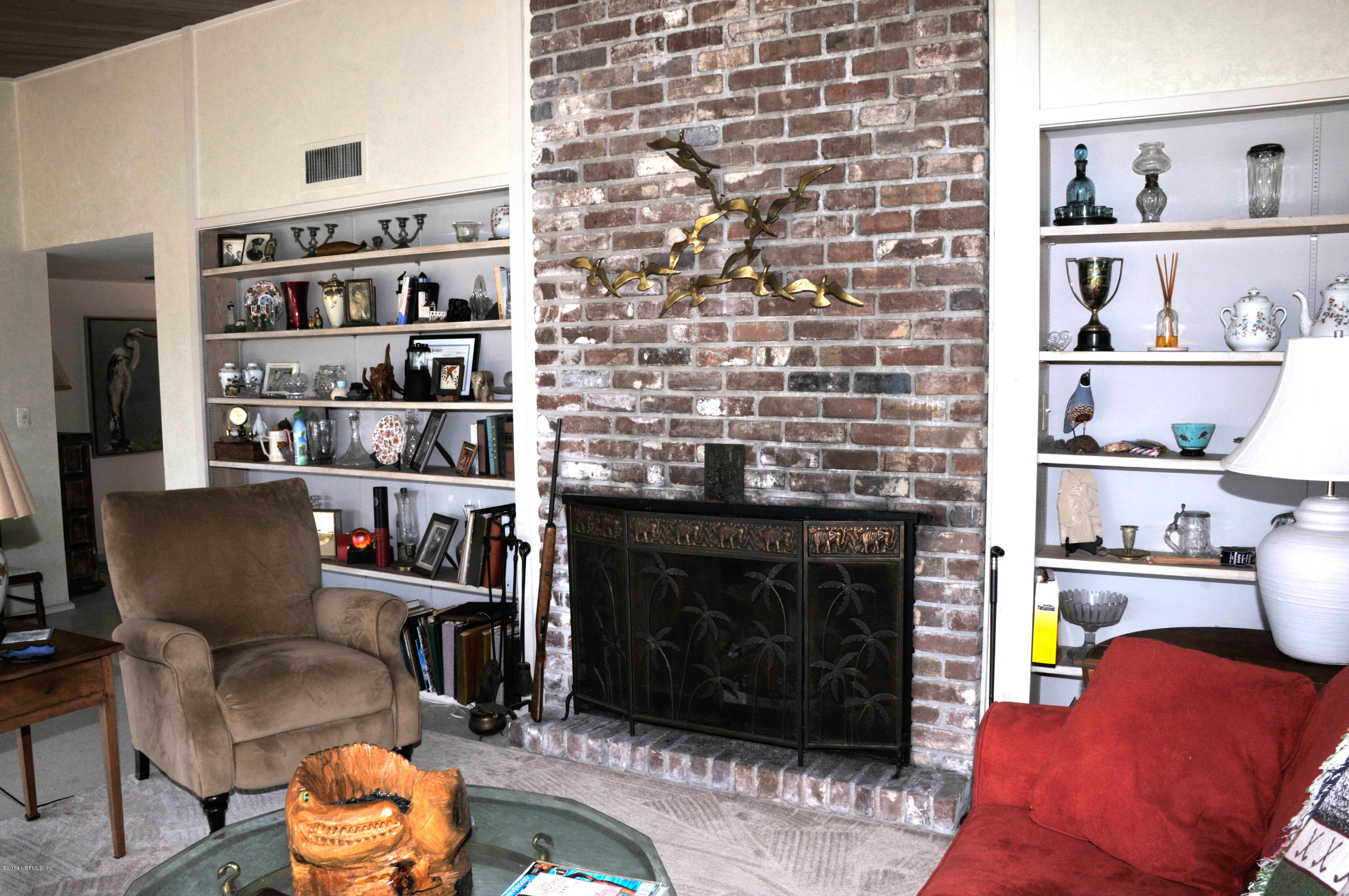 24 Solana Road Ponte Vedra Beach, FL 32082 - Photo 18 of 28 Living Room Fireplace and Book Cases
