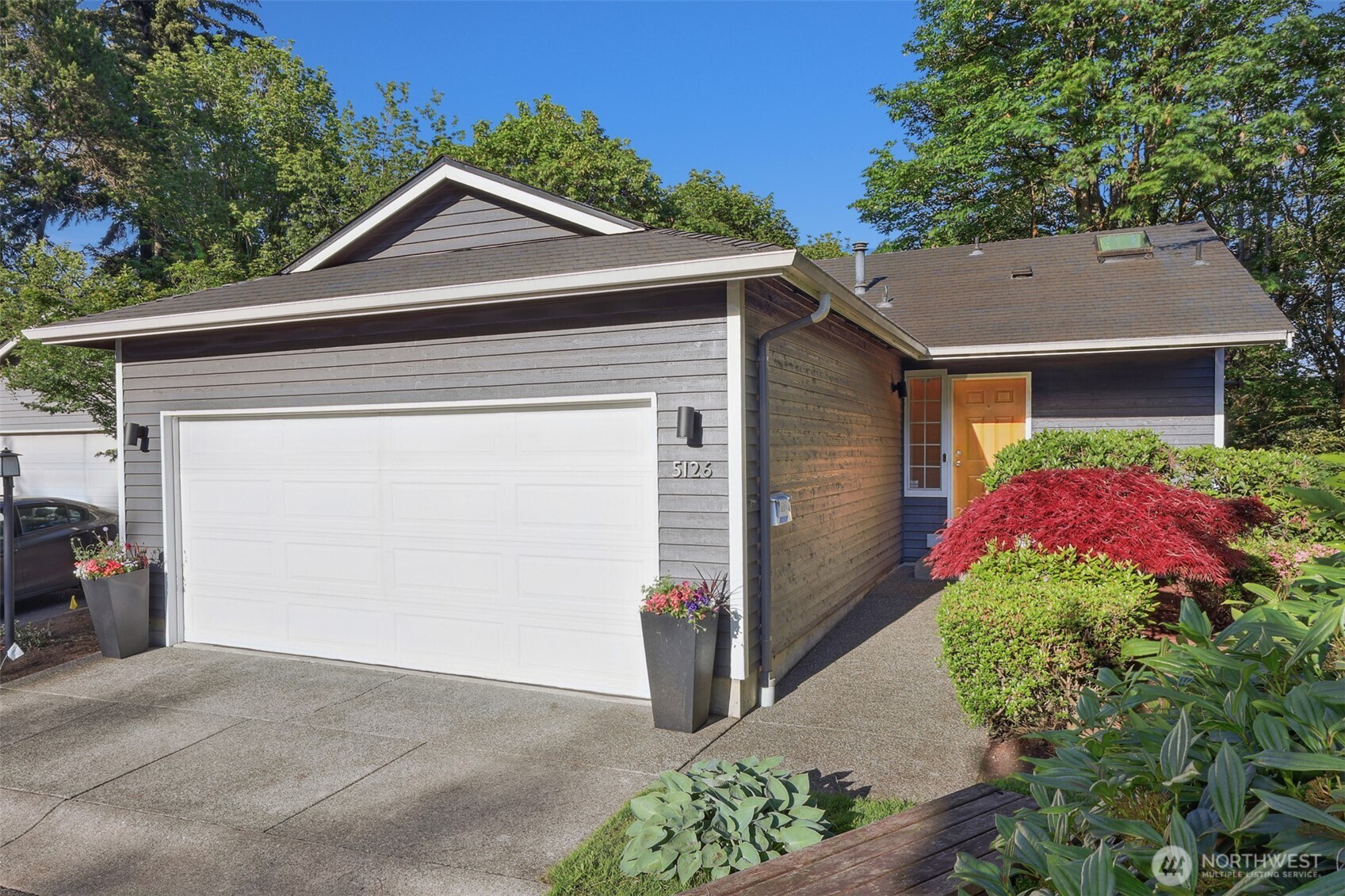 5126 South Garden Loop Road, Unit 11 Seattle, WA 98118 - Photo 1 of 36 a front view of a house with yard