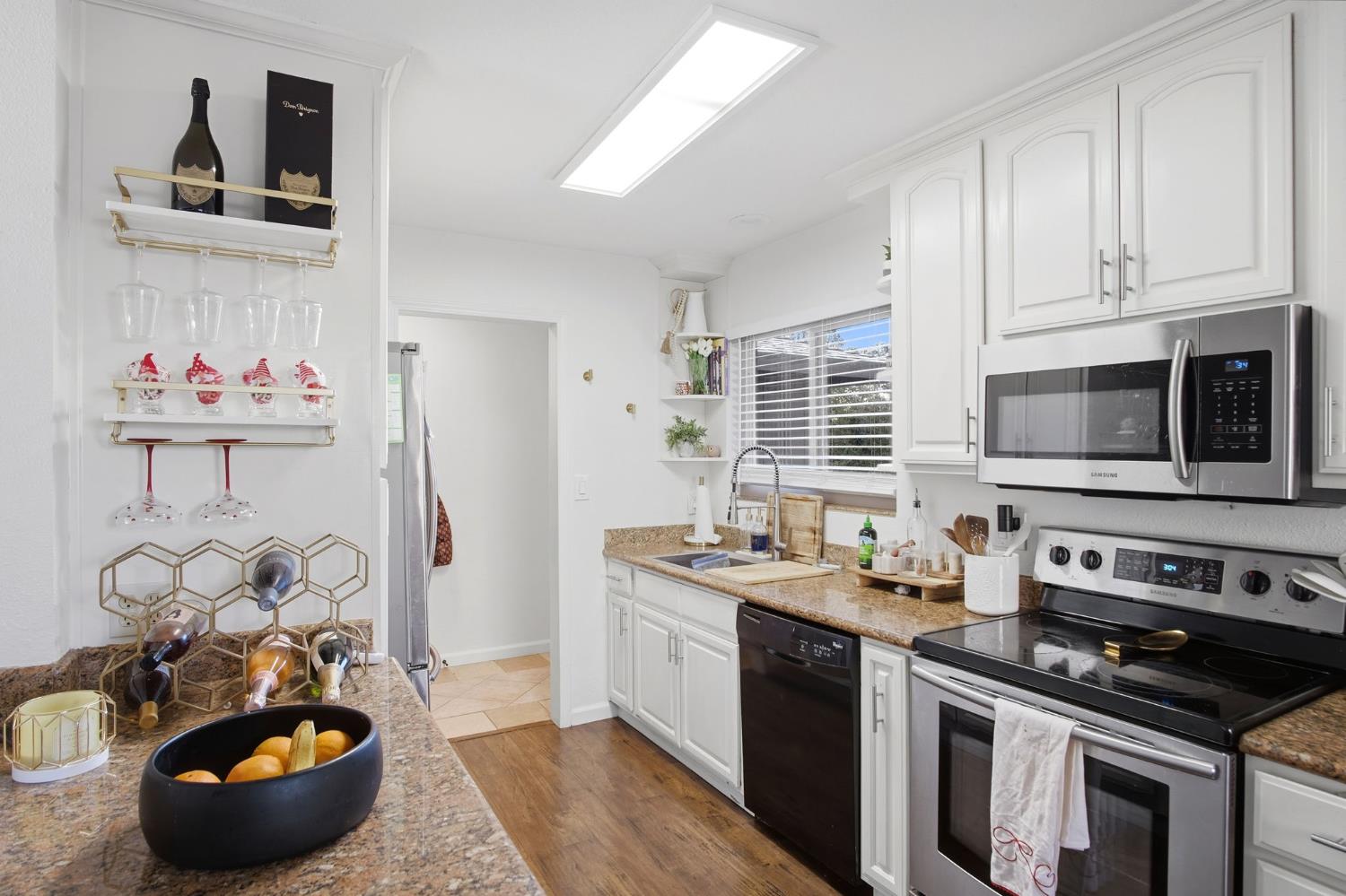 680 Sherri Way Turlock, CA 95382 - Photo 16 of 24 a kitchen with stainless steel appliances a stove a sink and a refrigerator