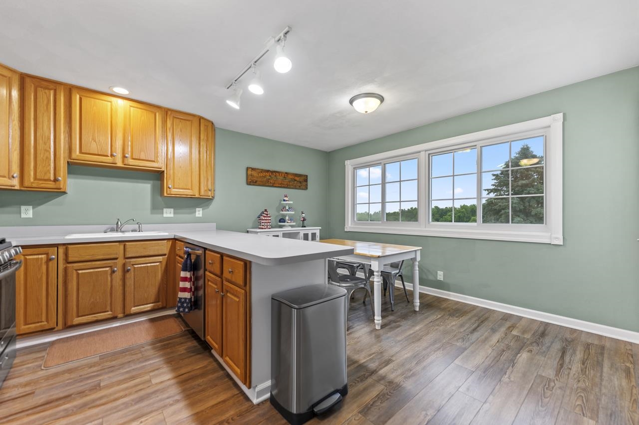 2108 Lake Summerset Road Lake Summerset, IL 61019 - Photo 15 of 53 a kitchen with stainless steel appliances granite countertop a stove a sink dishwasher and a microwave oven with wooden floor