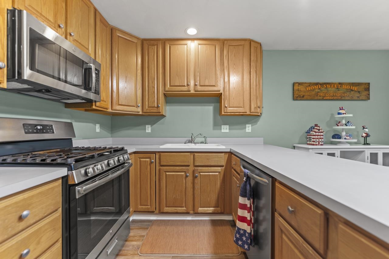 2108 Lake Summerset Road Lake Summerset, IL 61019 - Photo 16 of 53 a kitchen with stainless steel appliances granite countertop a stove a sink and a microwave