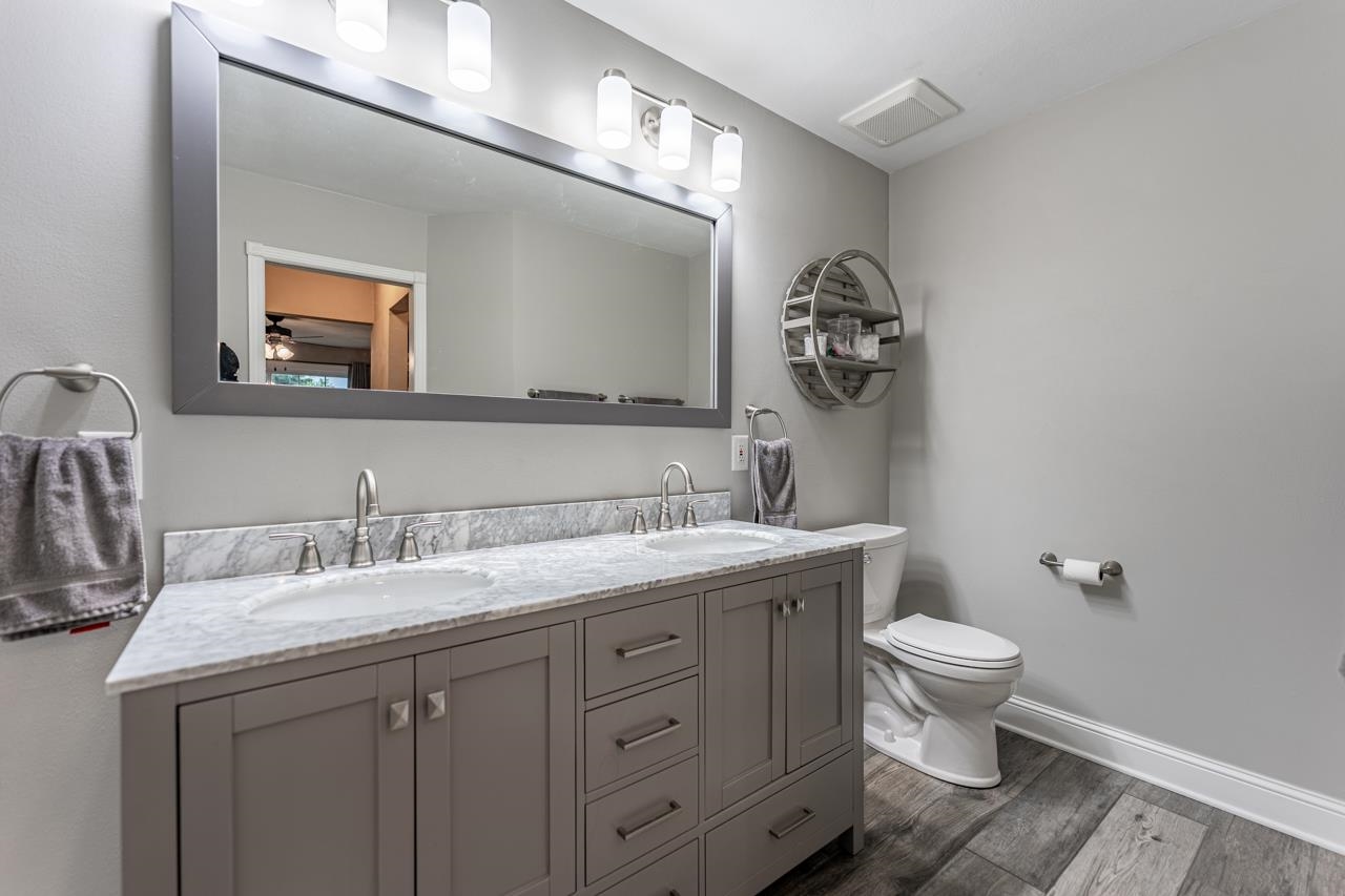 2108 Lake Summerset Road Lake Summerset, IL 61019 - Photo 25 of 53 a bathroom with a toilet sink and mirror
