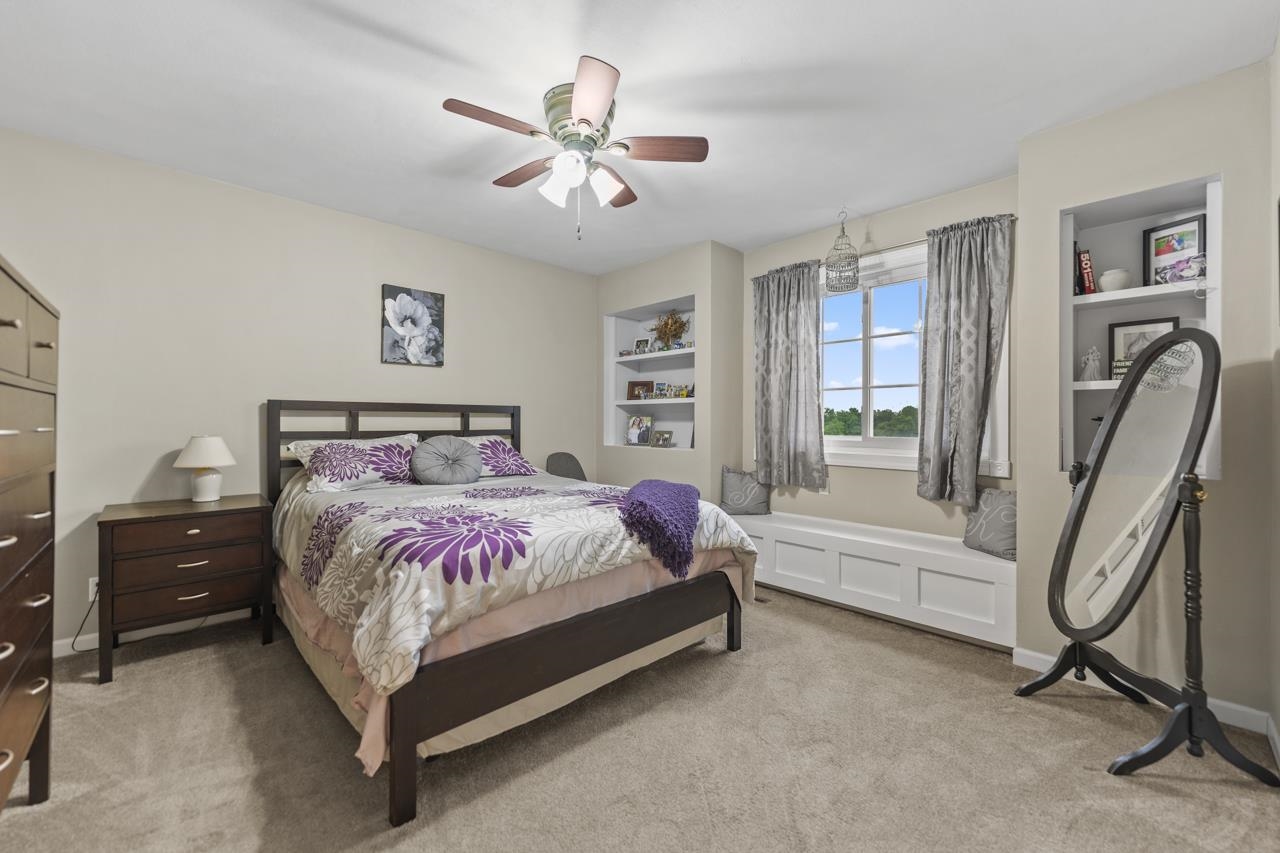 2108 Lake Summerset Road Lake Summerset, IL 61019 - Photo 28 of 53 a spacious bedroom with a bed a couch and a chandelier
