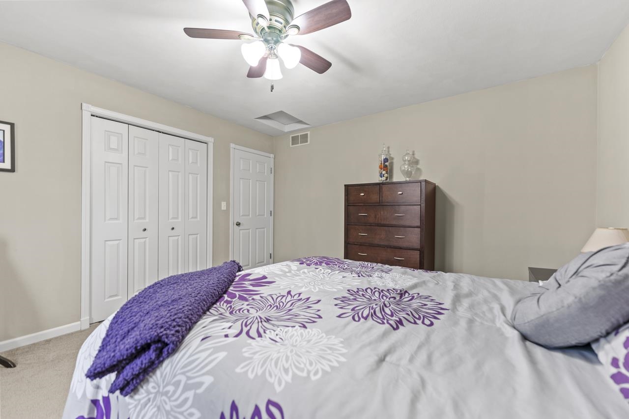 2108 Lake Summerset Road Lake Summerset, IL 61019 - Photo 29 of 53 a bedroom with a bed and a chandelier