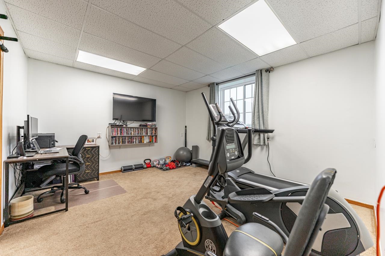 2108 Lake Summerset Road Lake Summerset, IL 61019 - Photo 32 of 53 a room with gym equipment and a flat screen tv