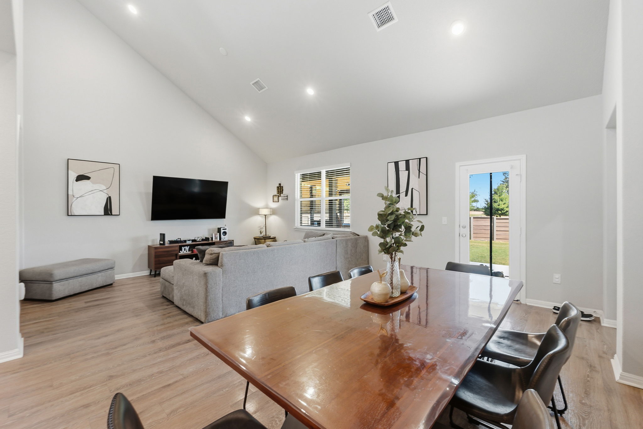 142 Brunnen Way Georgetown, TX 78626 - Photo 6 of 22 A spacious combined living and dining area boasts vaulted ceilings and bright recessed lighting.