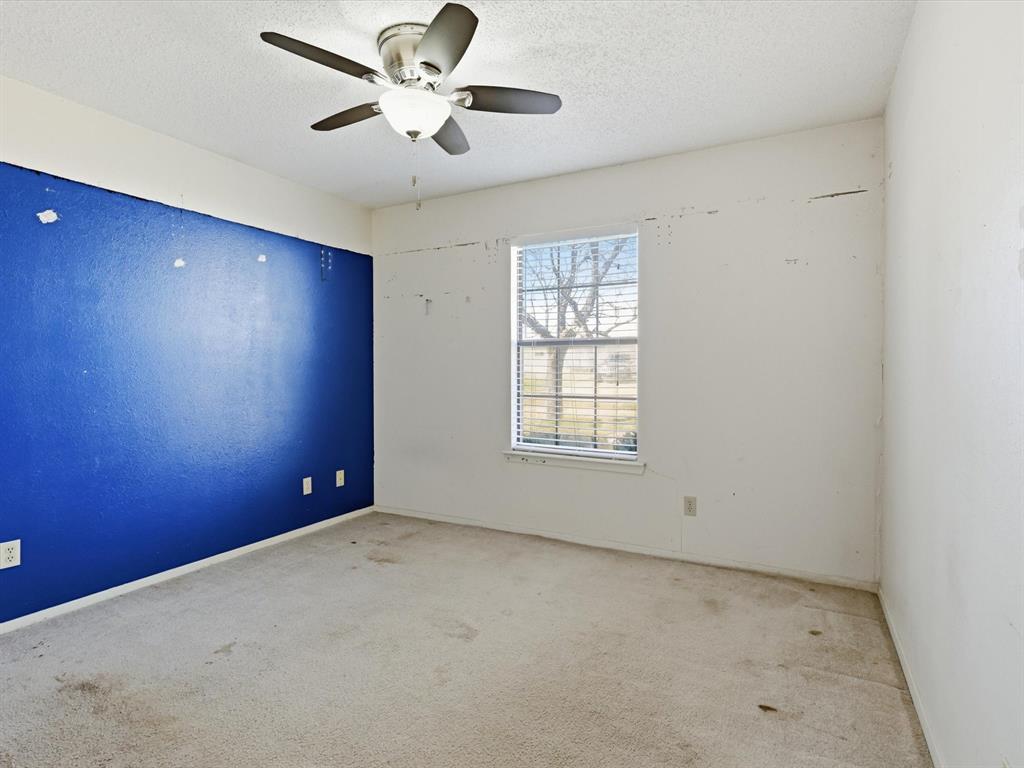 701 College Street Celeste, TX 75423 - Photo 19 of 29 an empty room with a ceiling fan and a window