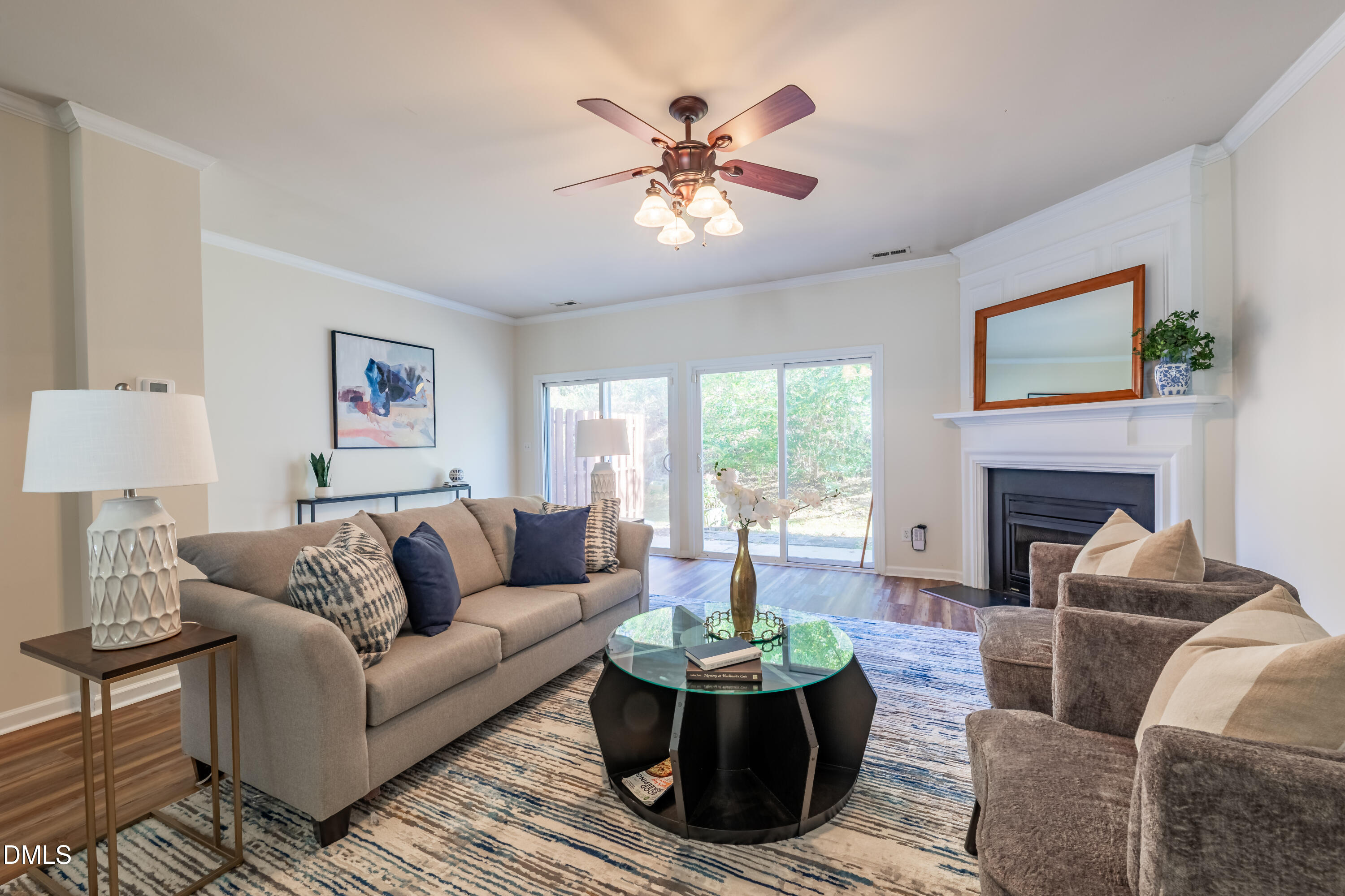 5209 Echo Ridge Road Raleigh, NC 27612 - Photo 3 of 16 a living room with furniture a chandelier and a fireplace