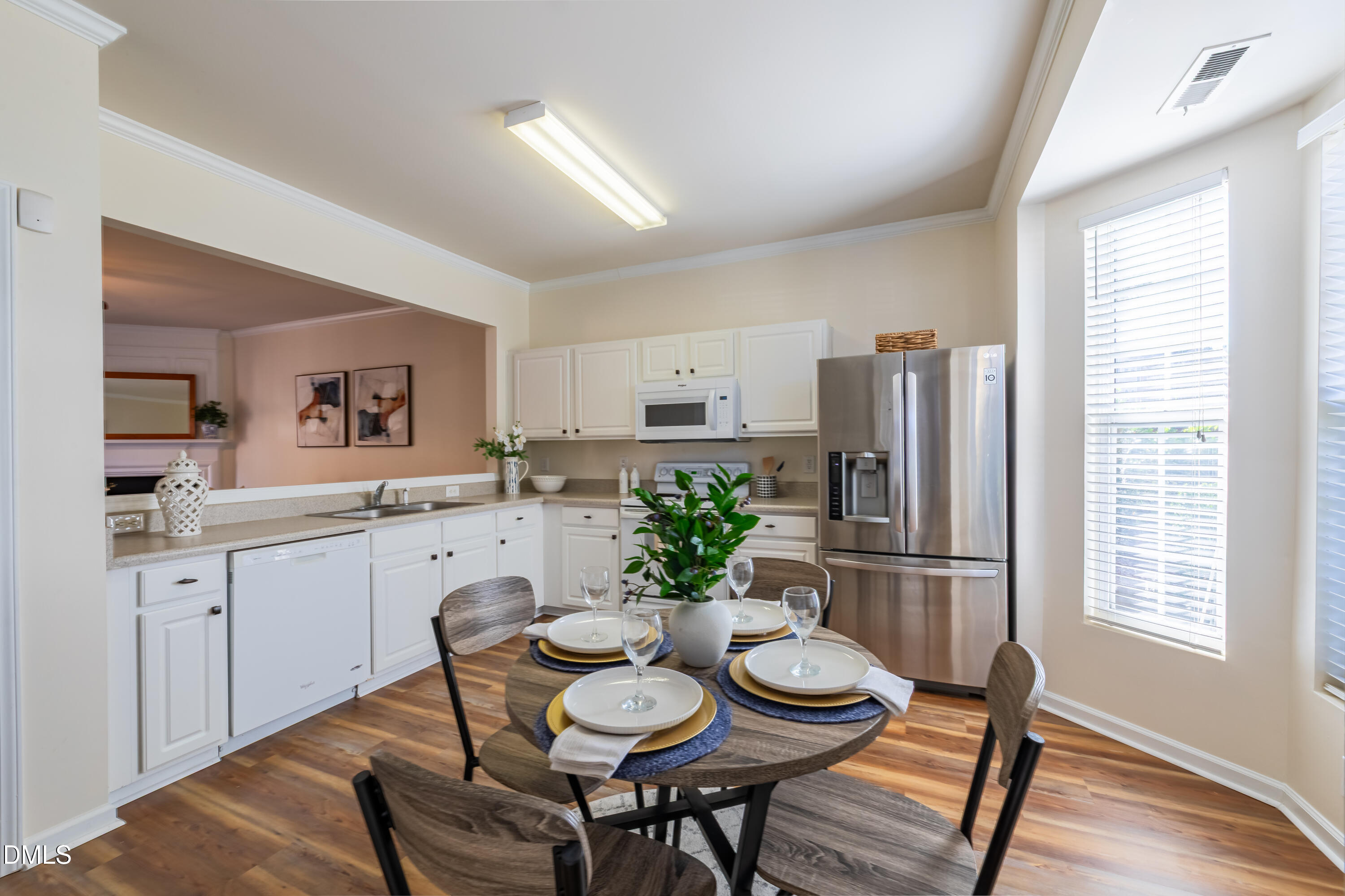 5209 Echo Ridge Road Raleigh, NC 27612 - Photo 7 of 16 a kitchen with stainless steel appliances granite countertop a dining table and chairs