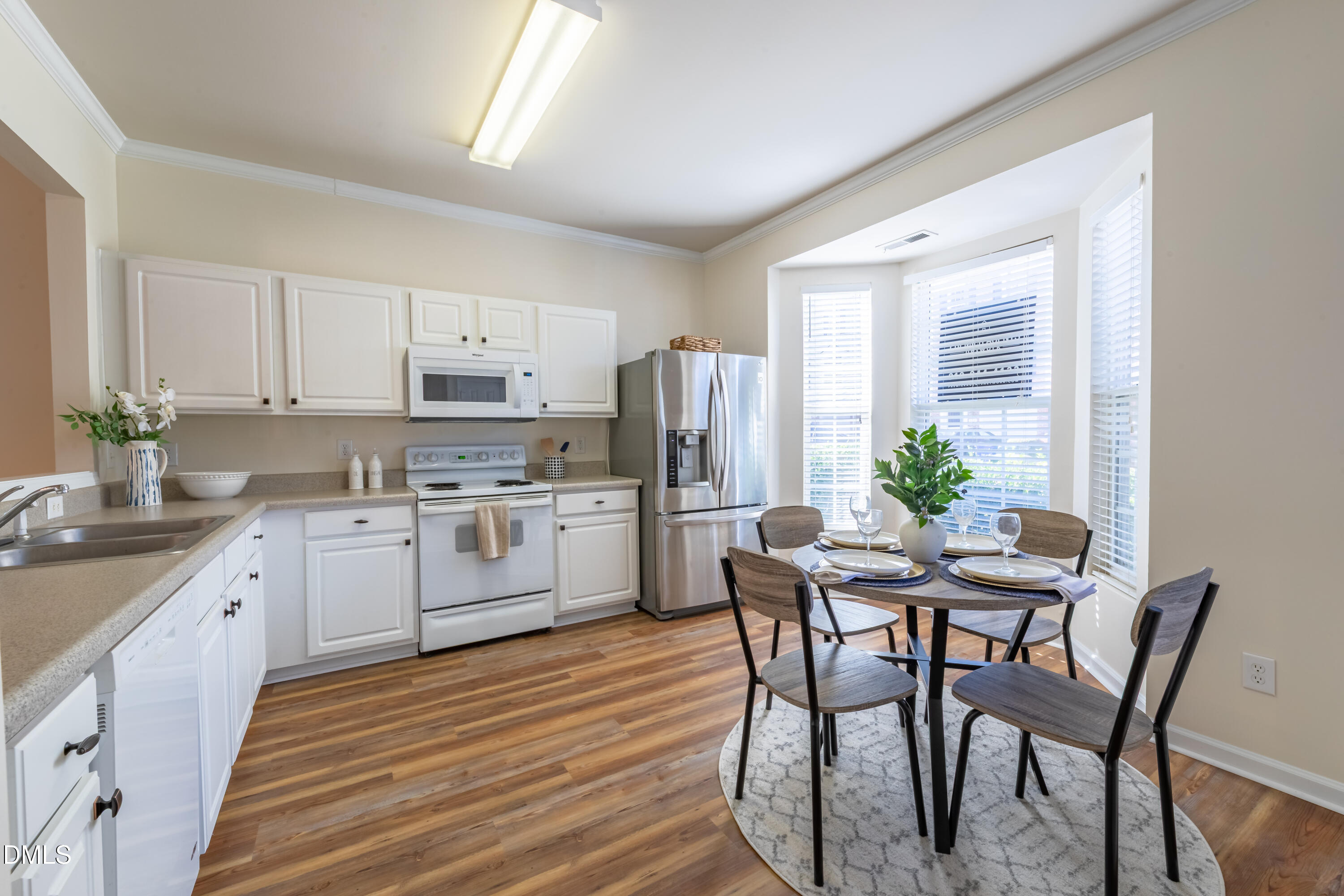 5209 Echo Ridge Road Raleigh, NC 27612 - Photo 8 of 16 a kitchen with a table chairs stove and cabinets