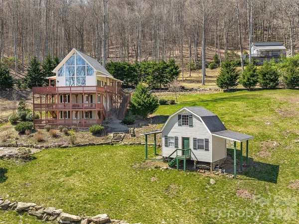 a aerial view of a house with a yard table and chairs