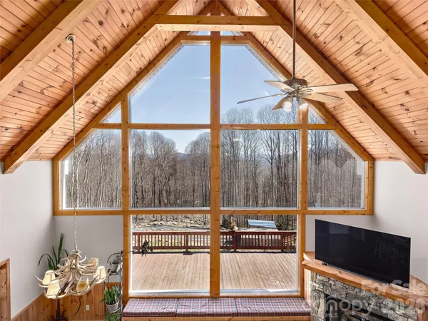 a view of a living room with a bed and a flat screen tv