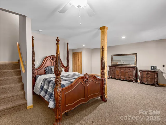 a bedroom with bed and a chandelier