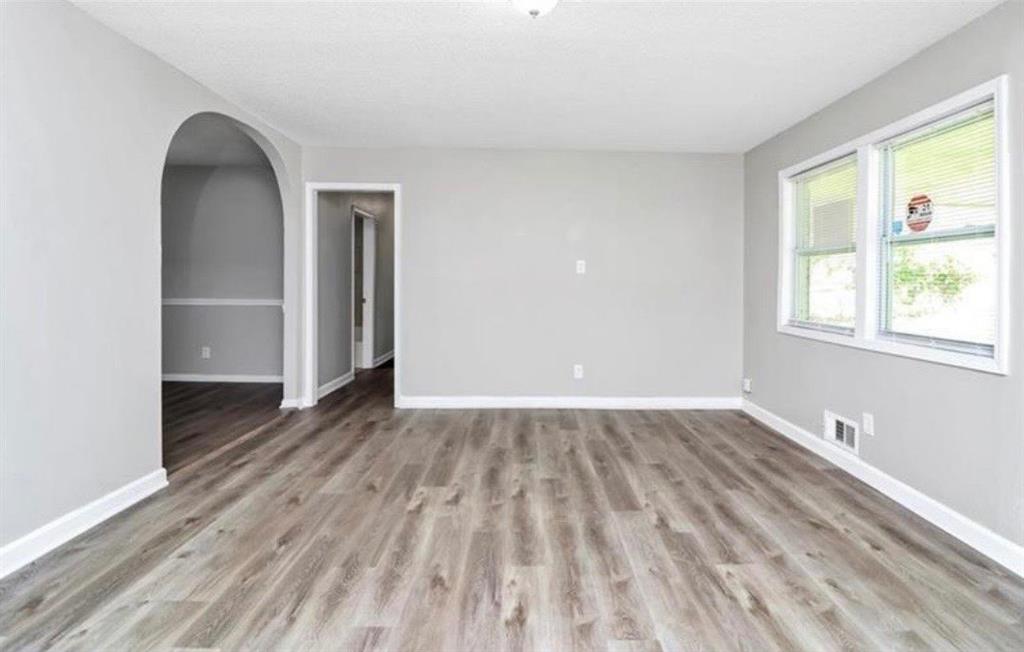 3711 Daisy Drive Decatur, GA 30032 - Photo 5 of 18 an empty room with wooden floor and windows