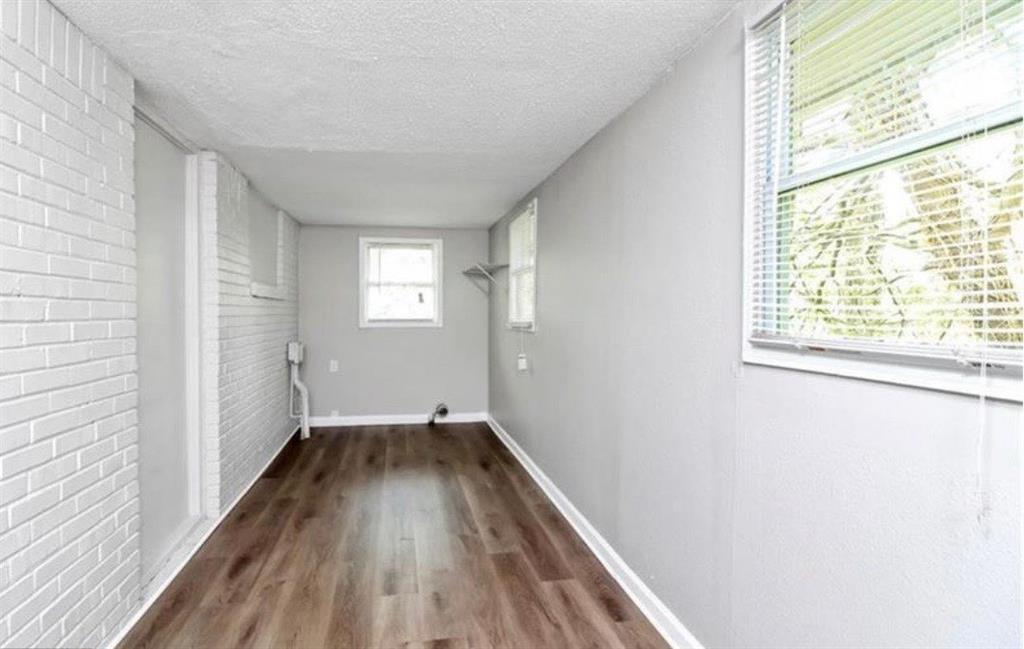 3711 Daisy Drive Decatur, GA 30032 - Photo 10 of 18 a view of hallway with window and wooden floor