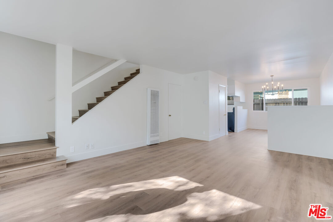 1813 9th Street, Unit 4 Santa Monica, CA 90404 - Photo 2 of 15 a view of a livingroom with wooden floor and stairs