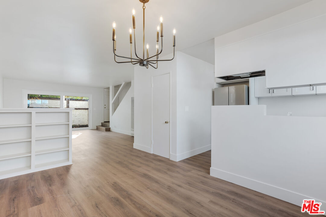 1813 9th Street, Unit 4 Santa Monica, CA 90404 - Photo 4 of 15 a view of a kitchen with wooden floor and ceiling fan