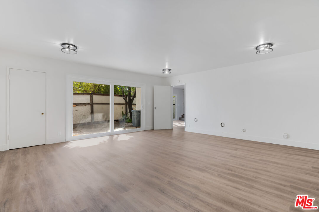 1813 9th Street, Unit 4 Santa Monica, CA 90404 - Photo 8 of 15 a view of an empty room with wooden floor and a window