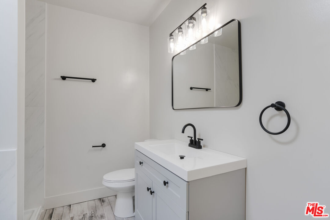 1813 9th Street, Unit 4 Santa Monica, CA 90404 - Photo 10 of 15 a bathroom with a toilet sink and mirror