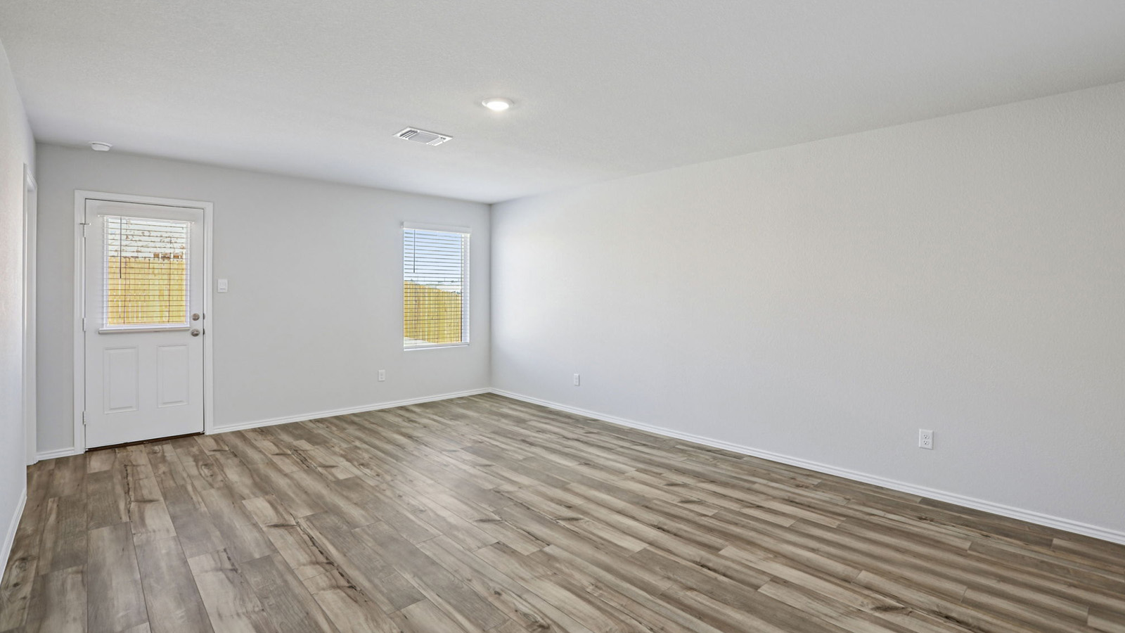 156 Wyatt Way Jarrell, TX 76537 - Photo 11 of 30 Spacious interior room featuring wood-finish flooring, light-toned walls, and recessed lighting
