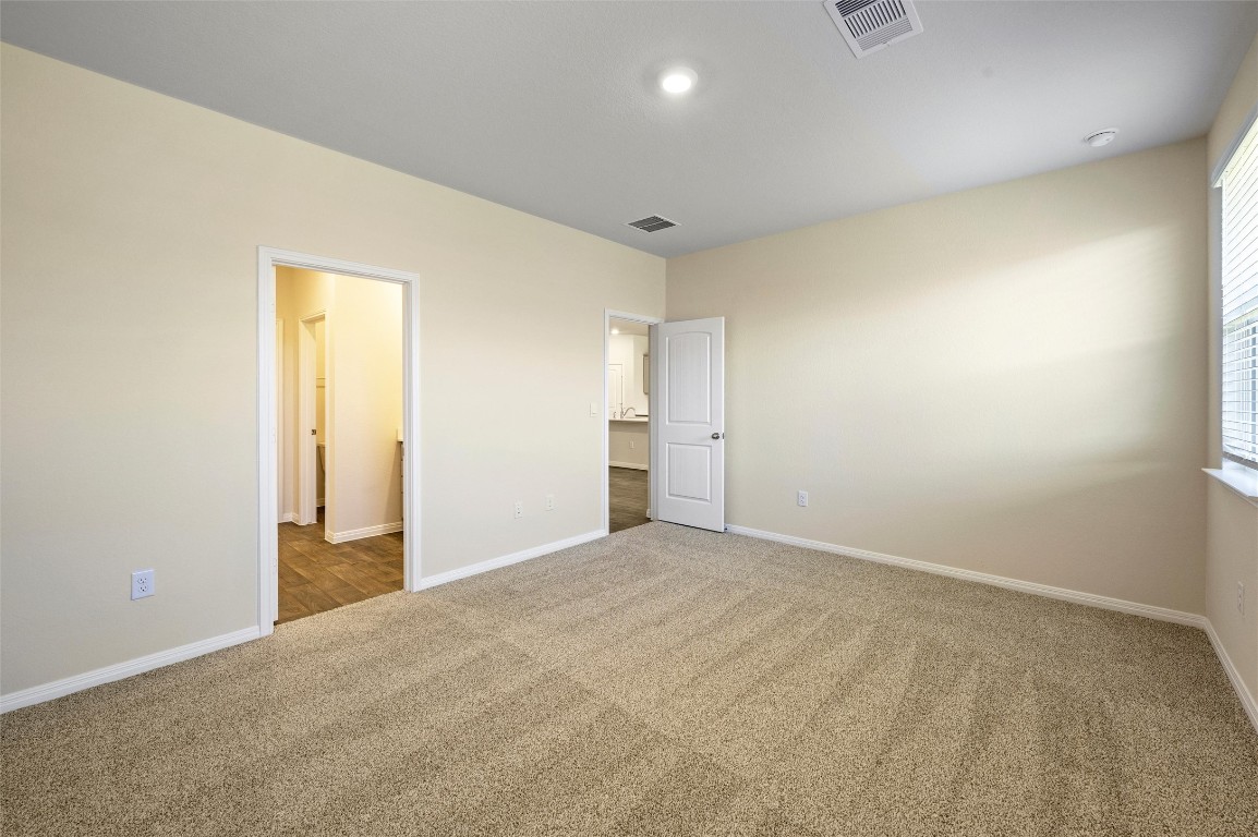 224 Kickapoo Lane Kyle, TX 78640 - Photo 12 of 31 Unfurnished bedroom with carpet floors and baseboards