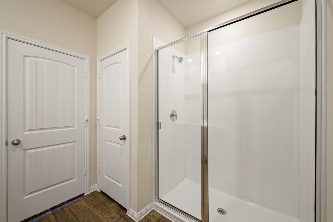 224 Kickapoo Lane Kyle, TX 78640 - Photo 14 of 31 Full bathroom with dark wood-style flooring and a stall shower