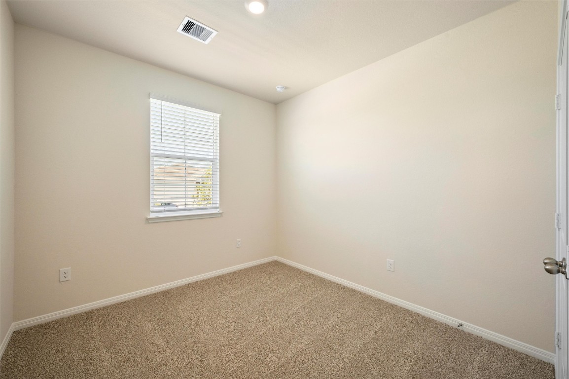 224 Kickapoo Lane Kyle, TX 78640 - Photo 16 of 31 Empty room featuring baseboards and carpet
