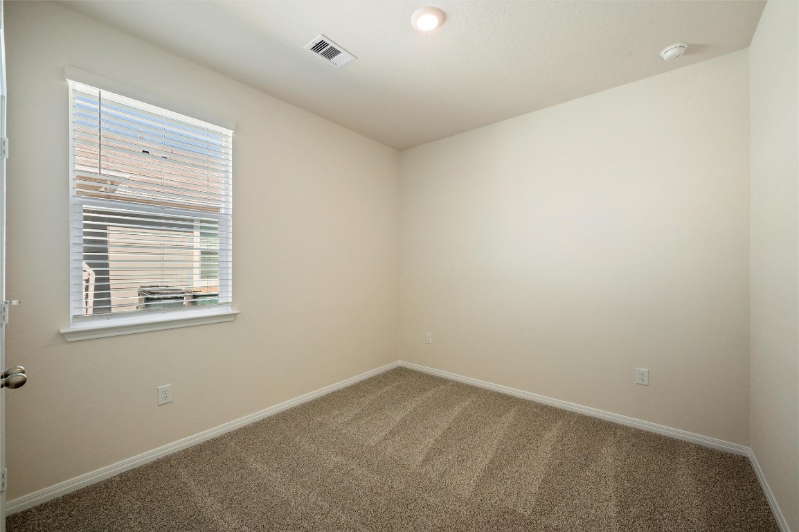 224 Kickapoo Lane Kyle, TX 78640 - Photo 19 of 31 Spare room featuring carpet floors and baseboards