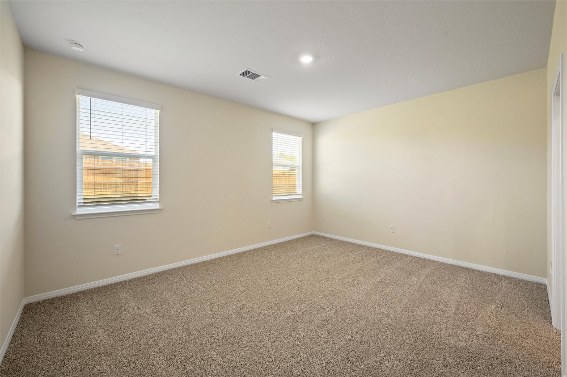 224 Kickapoo Lane Kyle, TX 78640 - Photo 22 of 31 Spare room with light carpet and baseboards
