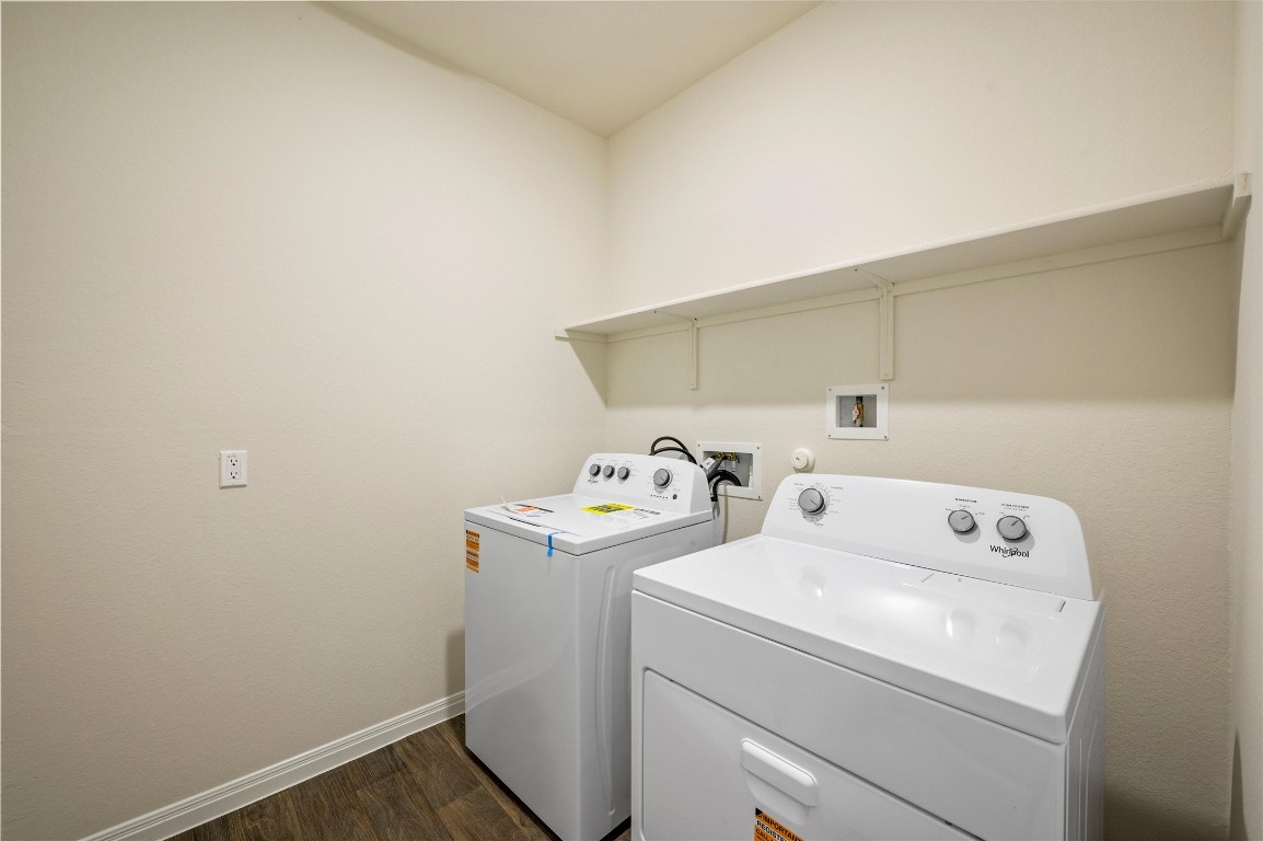 224 Kickapoo Lane Kyle, TX 78640 - Photo 23 of 31 Laundry area with washer and dryer and dark wood-type flooring