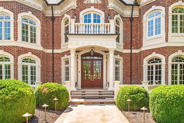 a kitchen with stainless steel appliances granite countertop a sink a stove and a refrigerator
