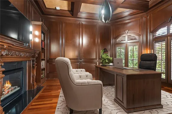 a view of a room with large windows and outdoor kitchen