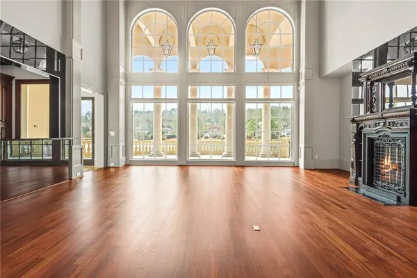 a large white kitchen with granite countertop a large window