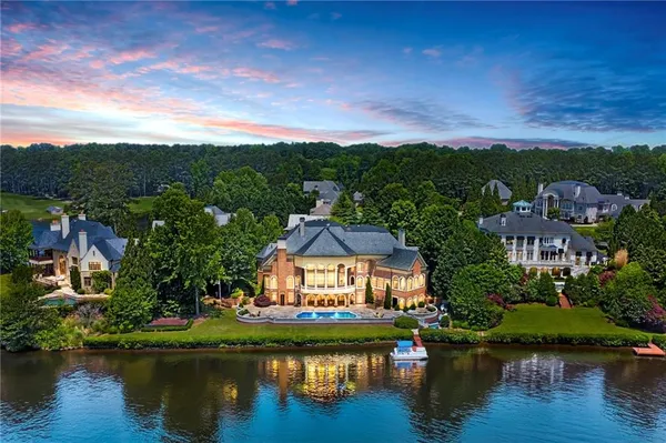 an aerial view of a house with a garden and lake view