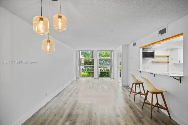 a view of a dining room with furniture wooden floor and chandelier
