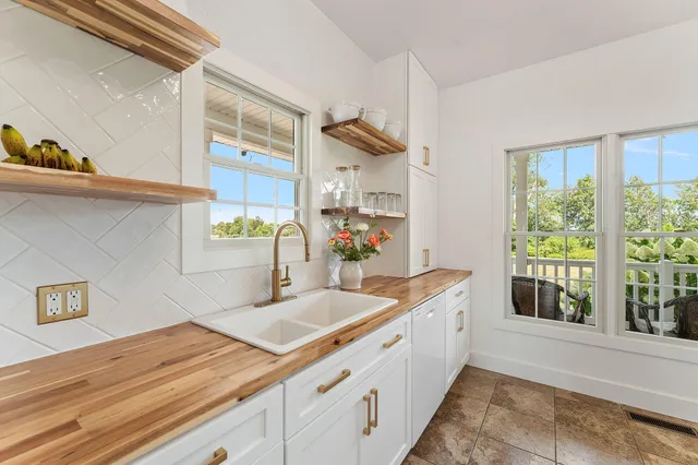 a kitchen with a stove and a wooden floor
