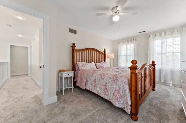 a bed sitting in a bedroom next to a window